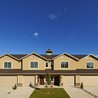 Row of two-story townhomes with attached garages and mountain views