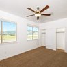Bedroom with ceiling fan and mountain-view windows