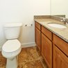 Bathroom with granite vanity and oak cabinets