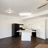 Open living area with wood-look floors and kitchen
