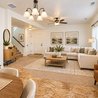 Open living and dining area with sectional sofa and ceiling fan