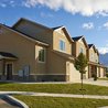 Two-story townhomes with stone accents and mountain views