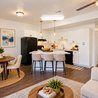 Furnished open-plan kitchen with island and white cabinets