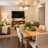 Furnished living and dining area with wood table