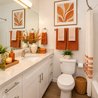 Bathroom with white vanity and orange accents