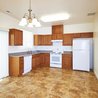 Kitchen with oak cabinets and dining area chandelier